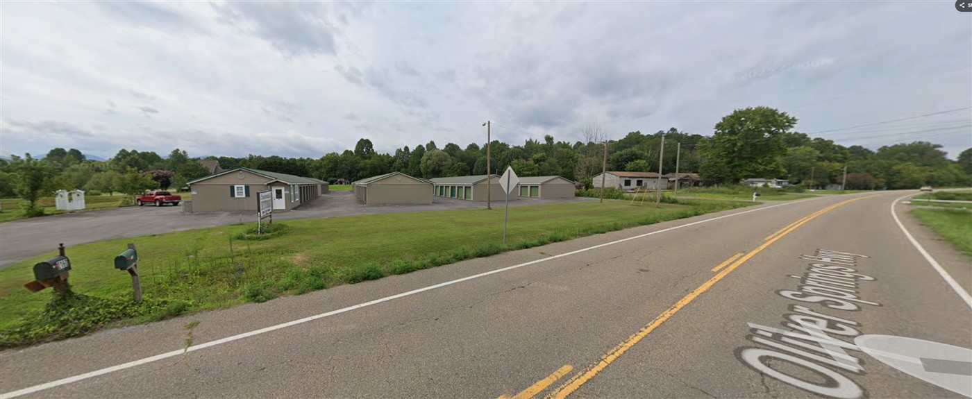 Storage buildings and paved drive aisles beside Oliver Springs Highway